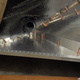 Inside the rear fender, next to the usual access hole for the (now missing) torsion bar.